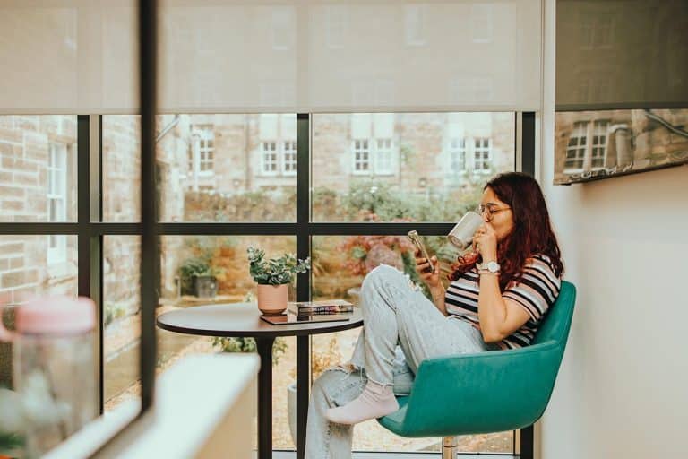 Student drinking coffee in apartment